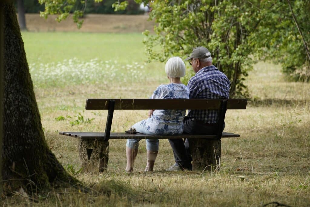 couple sitting on bency